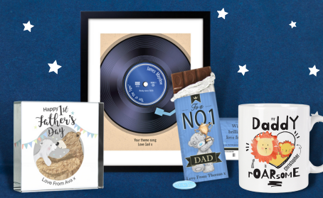A range of customised and personalised Father's Day presents unique to dad! A glass picture frame personalised recorded in a frame, no.1 dad chocolate bar and a ‘my daddy roar-some’ mug against a dark blue background with silver stars.